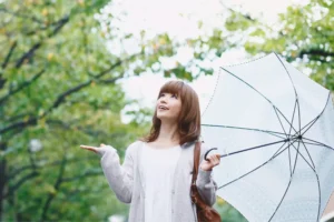 a woman holding an umbrella, she is single and still complete