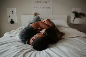 a couple, living in sin, lying on a bed together