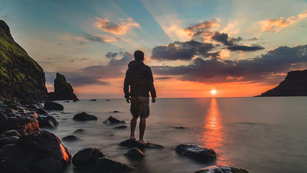 man on beach at dawn time