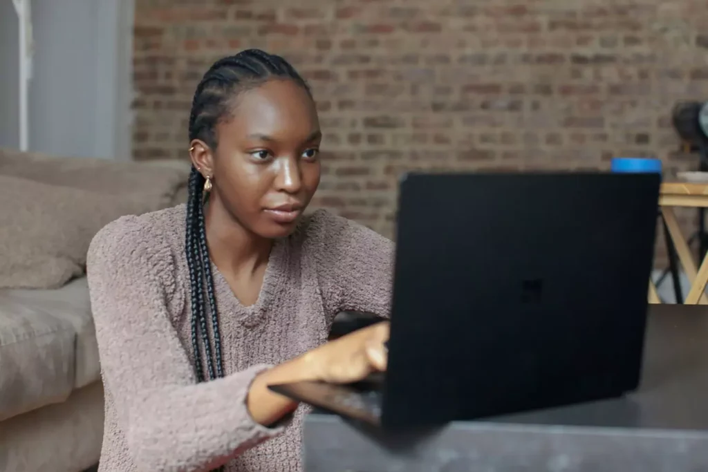 a woman working on a laptop preparing for a job interview
