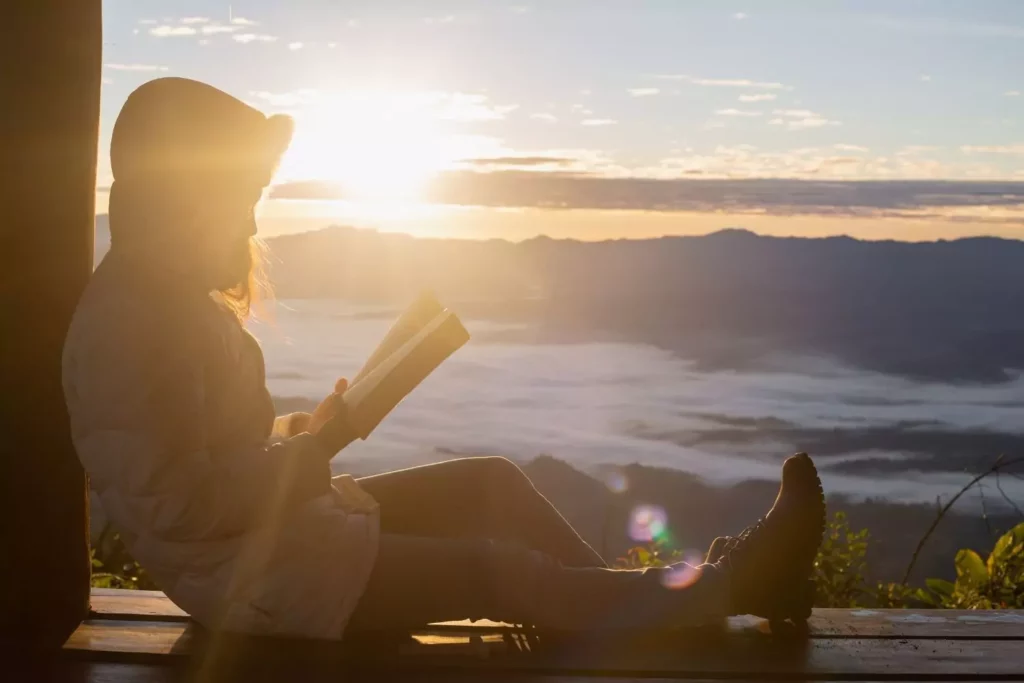 woman reading the Bible in a window sill