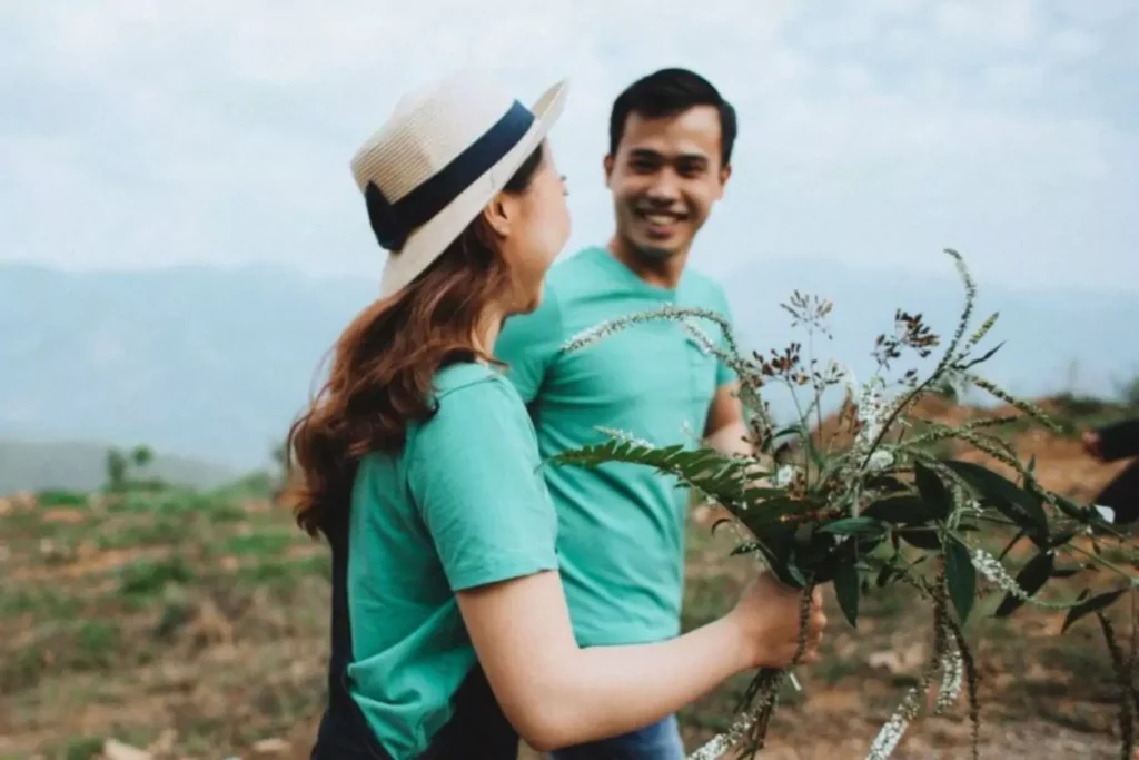 a woman holding flowers, walking with a man. What is our calling?