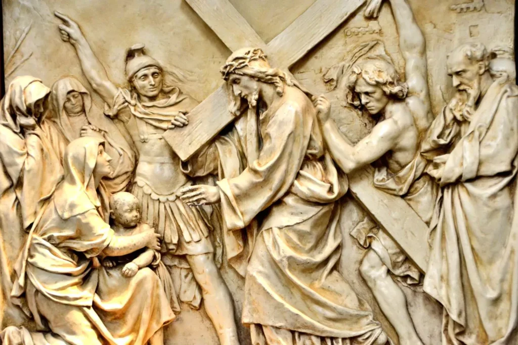 stone artwork of Jesus carrying the cross