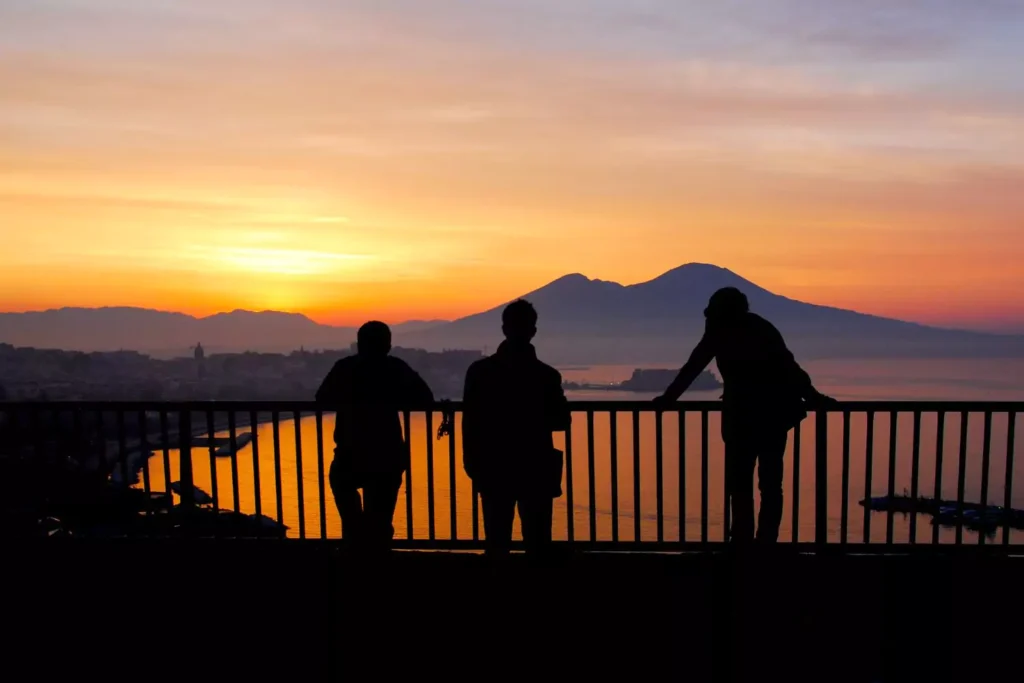 Three friends looking at a sunrise over a mountain thinking about the resurrection of Jesus