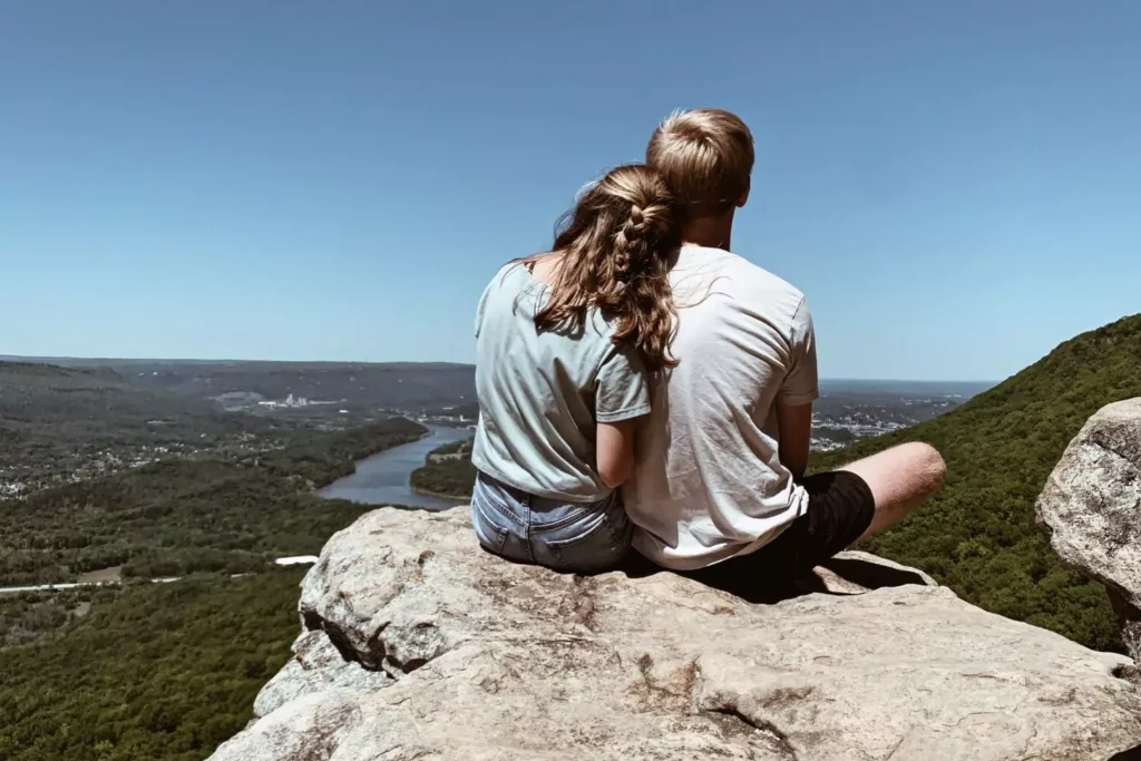 Janson and author Maggie on a rock overlooking a city - discussing dating boundaries