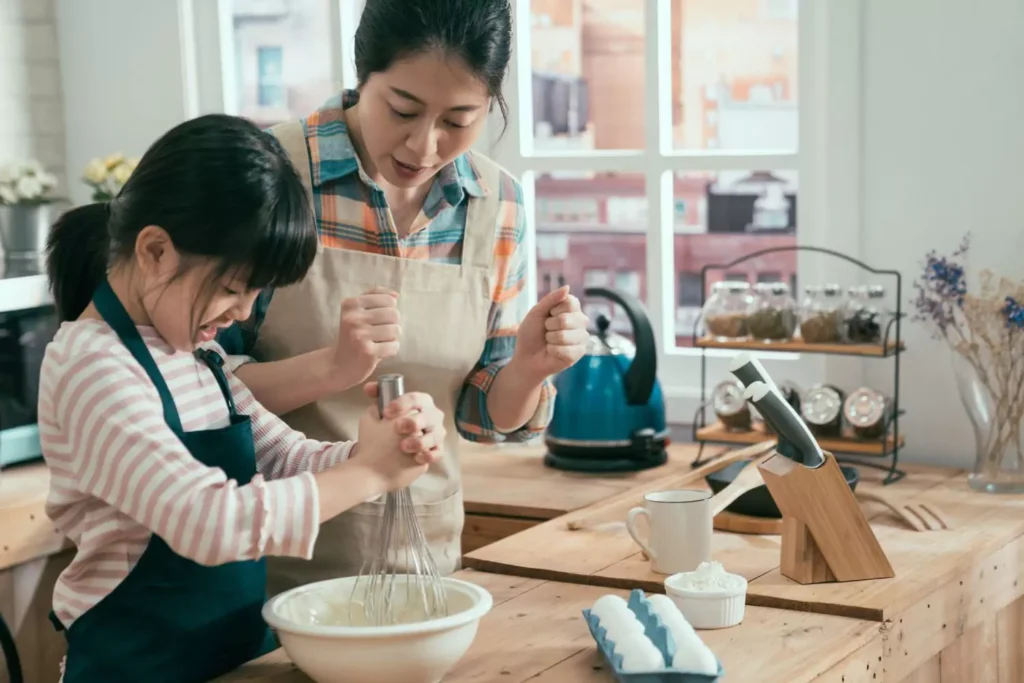 a child asking as helper in baking with her mom