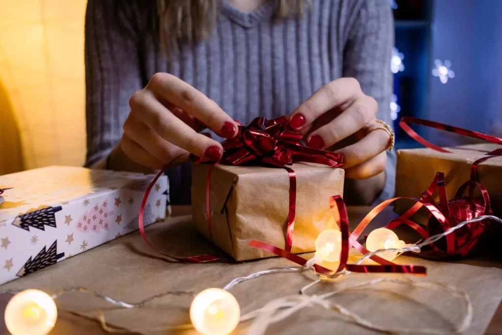 woman wrapping a Christmas gift