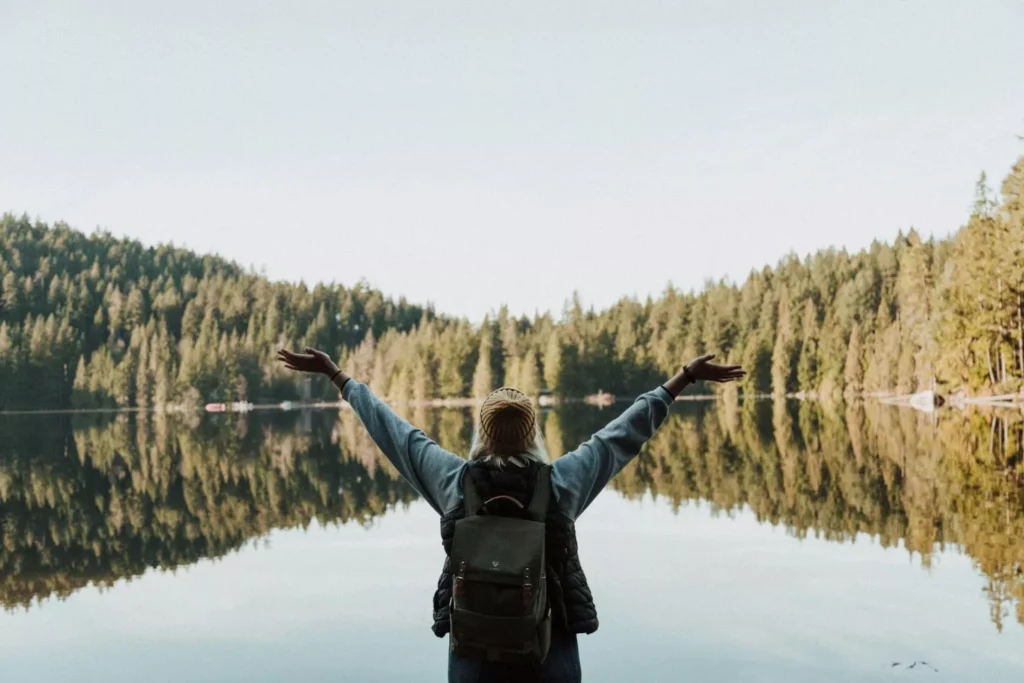 a woman feeling joy, with her hands raised
