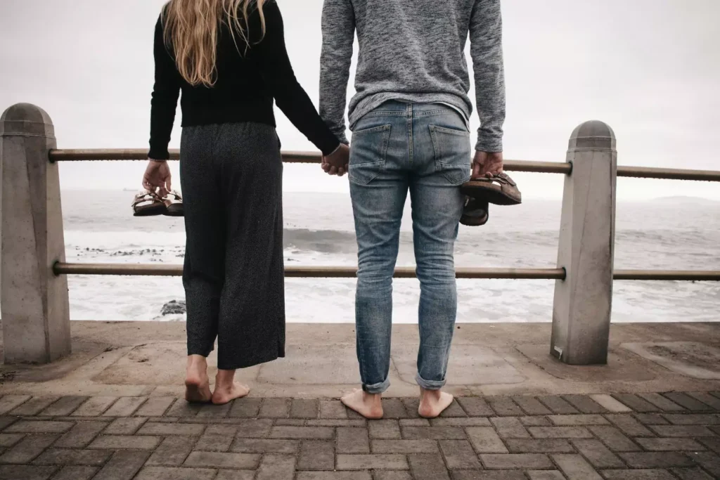 a couple holding hands looking out over the water talking about reestablishing sexual boundaries