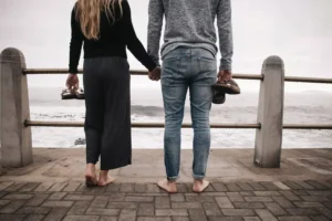 a couple holding hands looking out over the water talking about reestablishing sexual boundaries