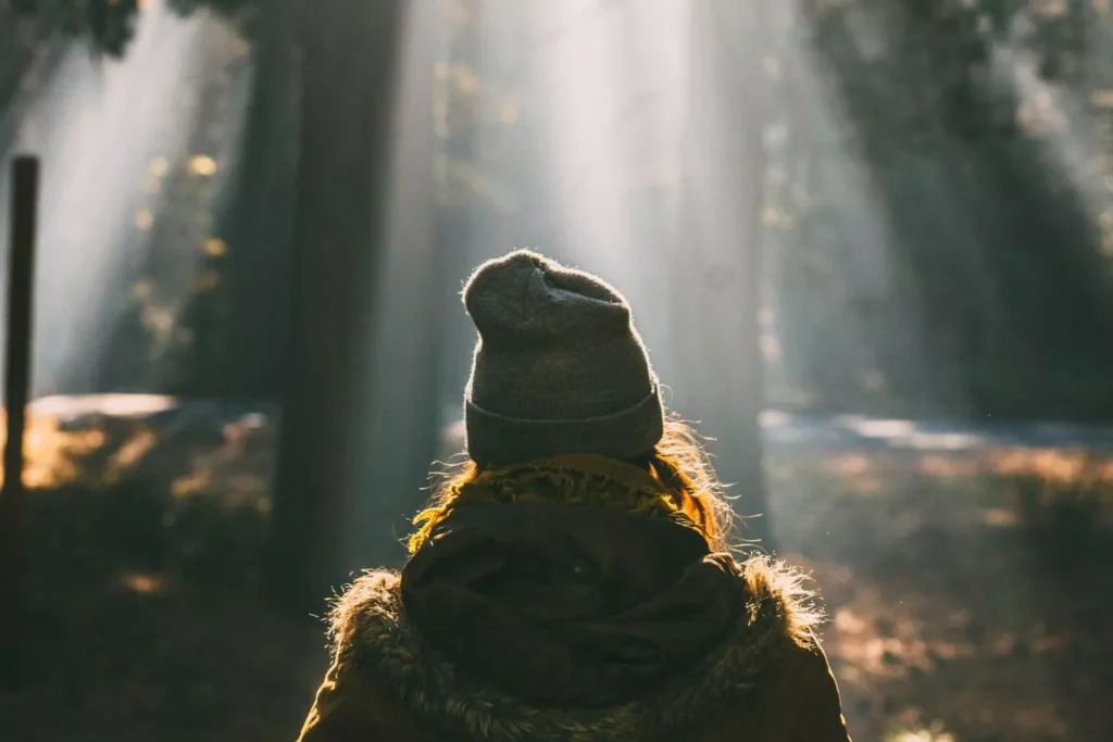 a woman standing in sun rays longing for wisdom