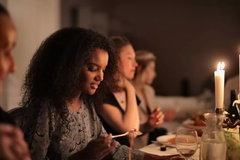 Woman at a holiday dinner looking at her plate.