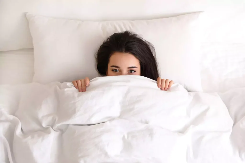 A woman hiding under bed covers thinking is masturbation ok?