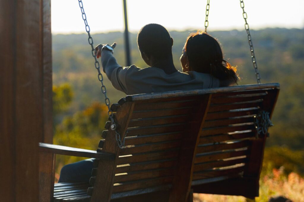 a couple on a date, sitting on a porch swing