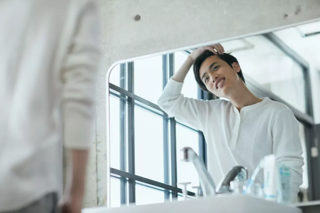 a man looking at himself in the mirror, he needs some humility