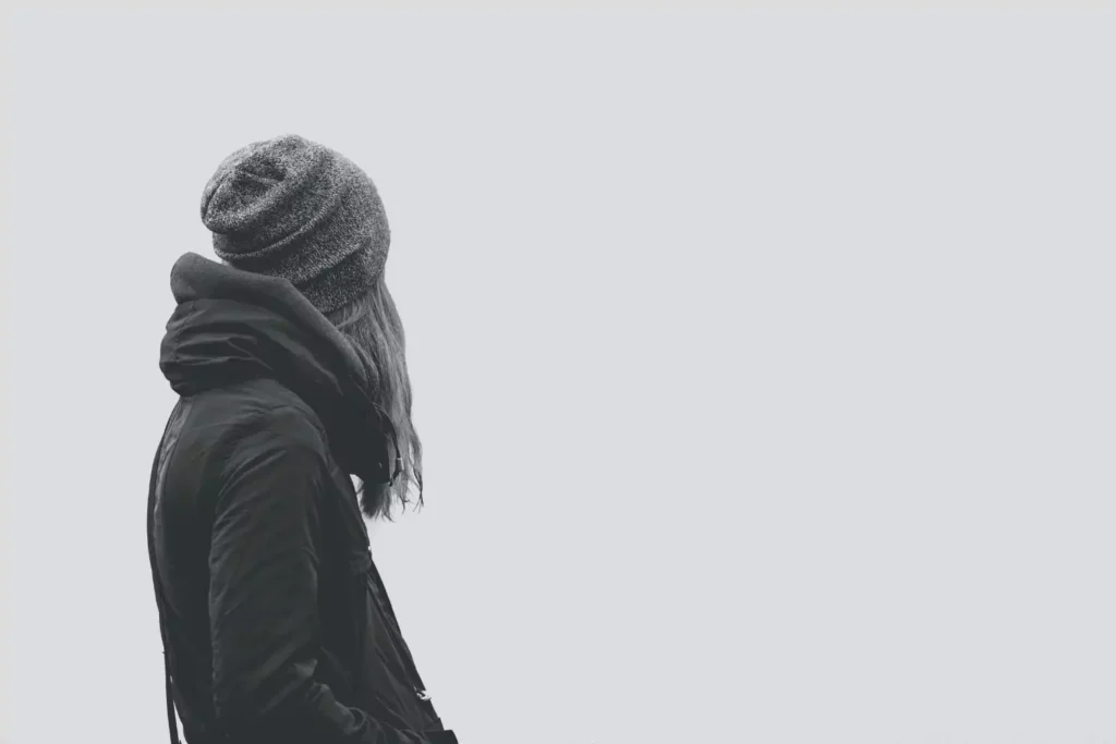 a black and white image of a woman alone - forgotten