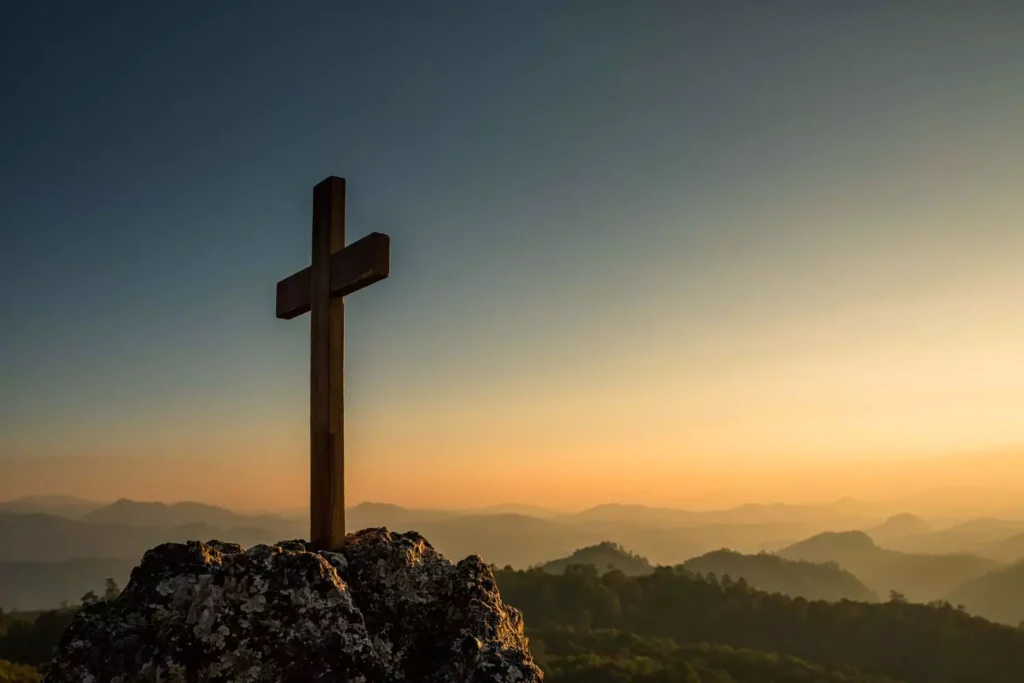 a cross on a hill at sunset, tetelestai