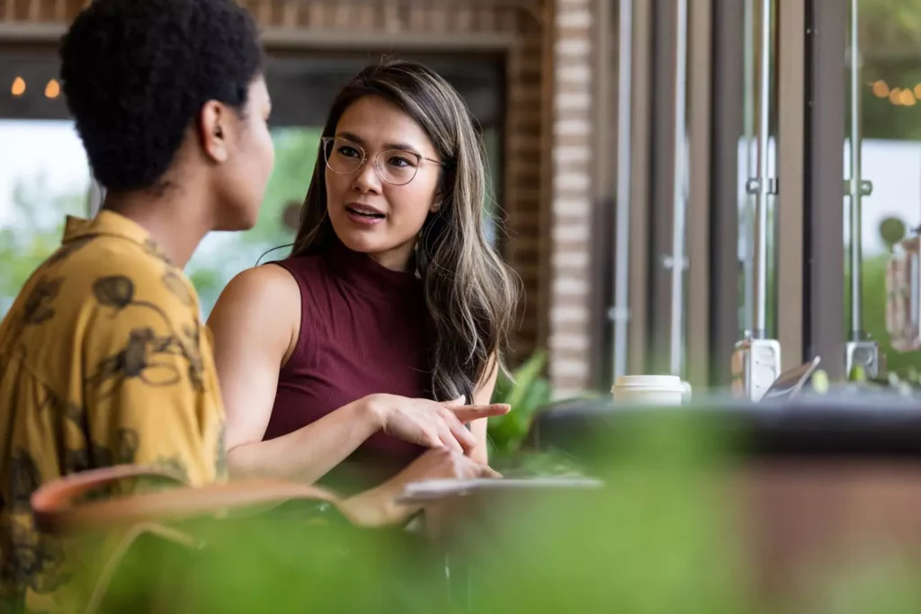 two women talking, one receiving feedback from the other