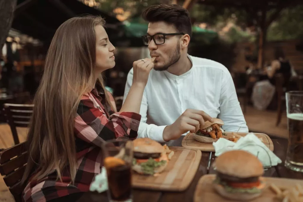 girlfriend feeding her boyfriend a french fry