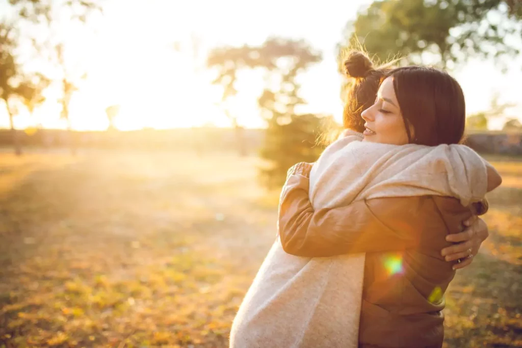 two women hugging, expressing approval