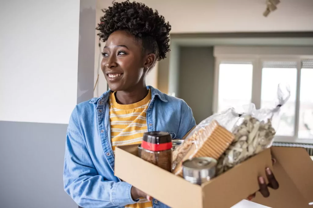 woman holding a box of food. Selflessness