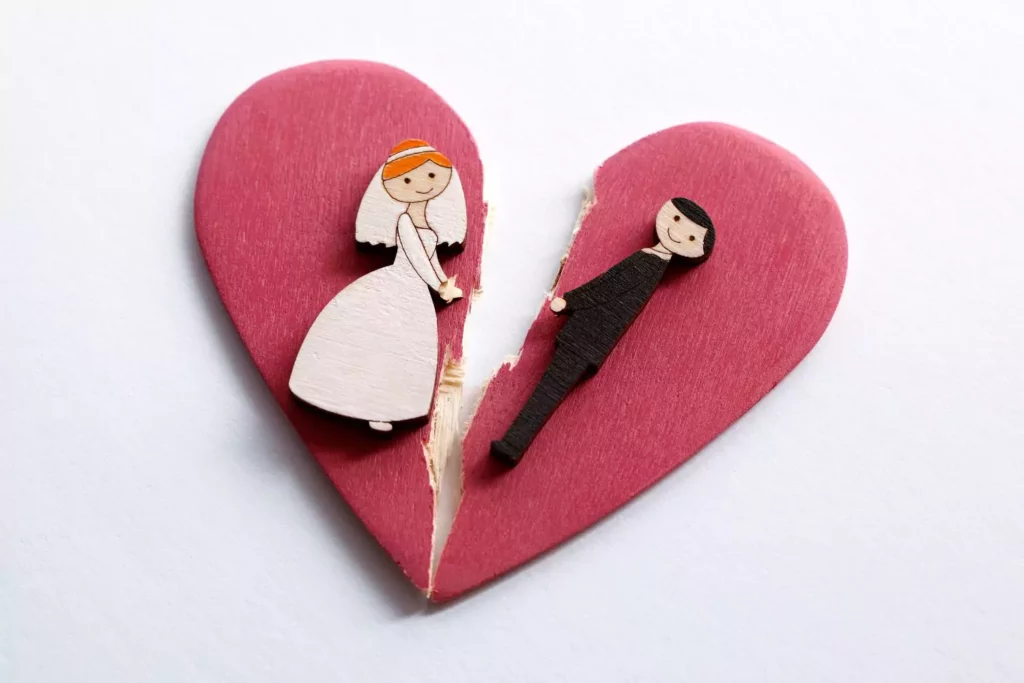 bride and groom on a wooden ornament, broken in half - broken engagement