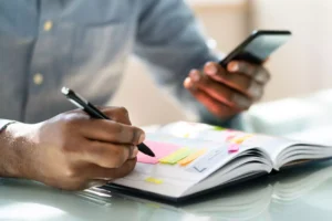 a man trying to improve his productivity by using a planner