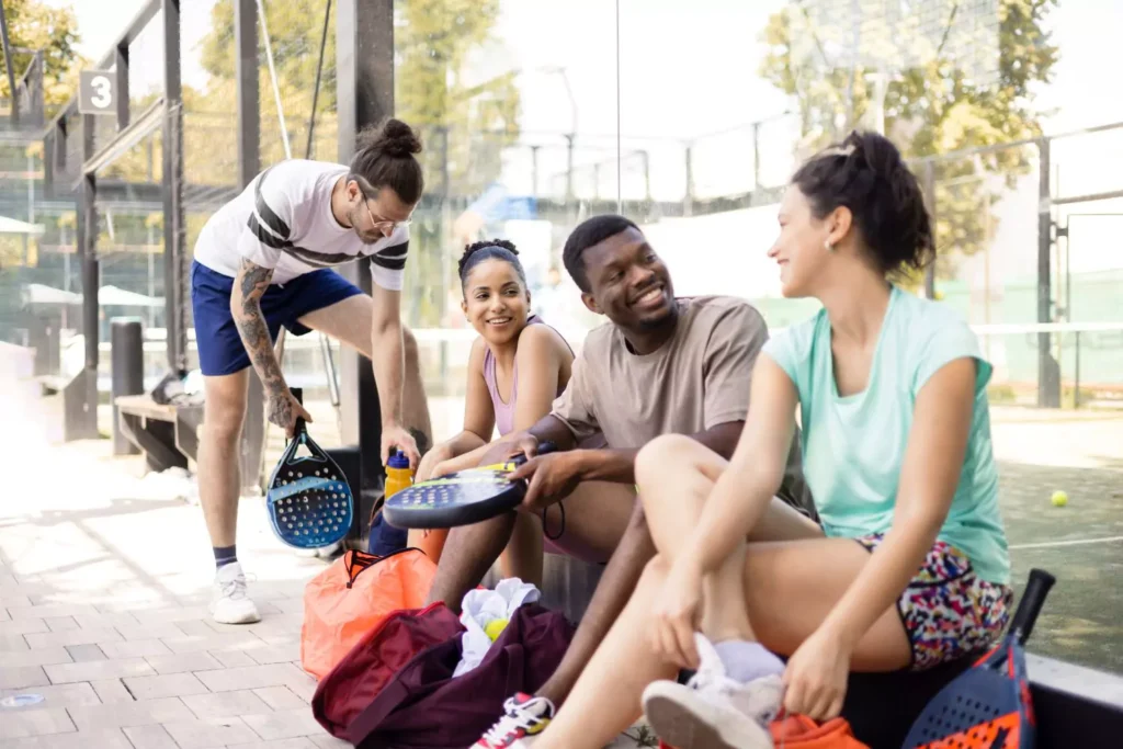 a group of young adults playing pickleball, they have ditched the dating apps