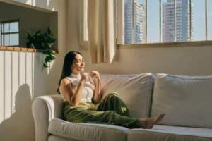 a woman decluttering her mind by relaxing on the couch