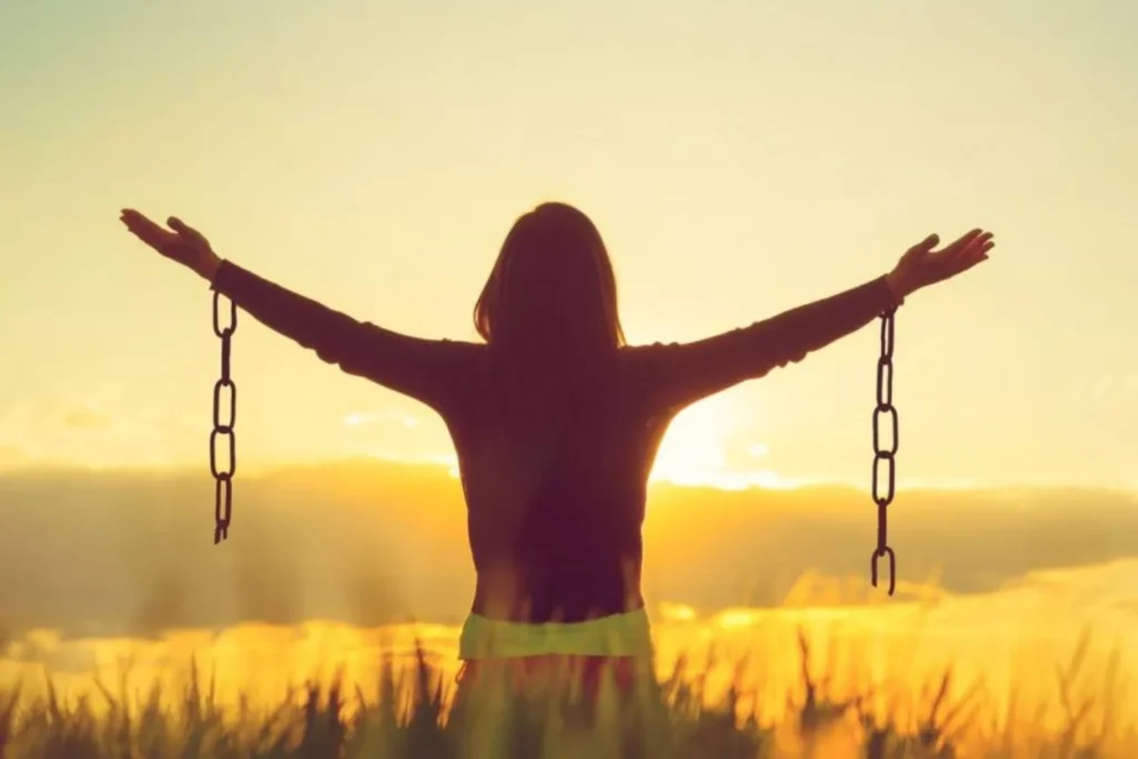 a woman with broken chains on her wrists - she's free from pornography