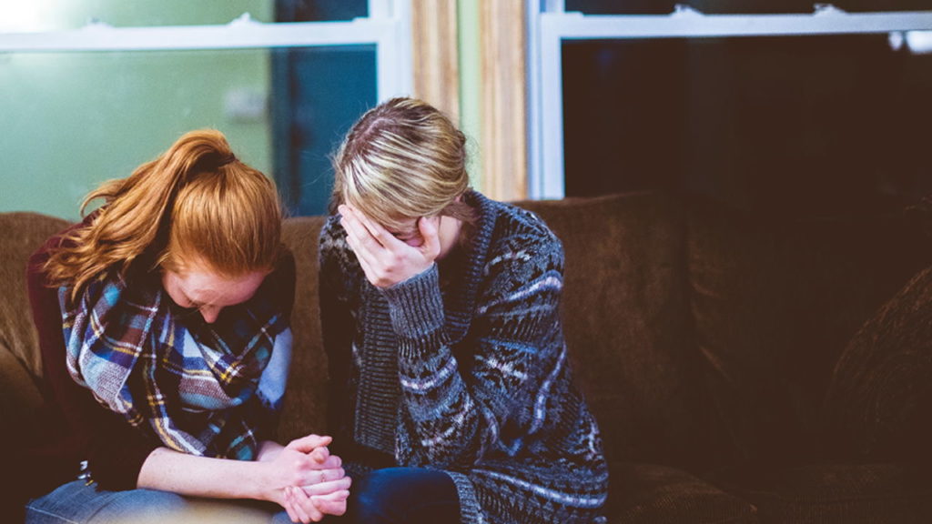 People crying on a couch