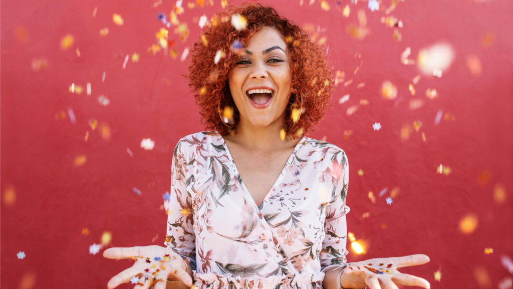 woman smiling with confetti around her