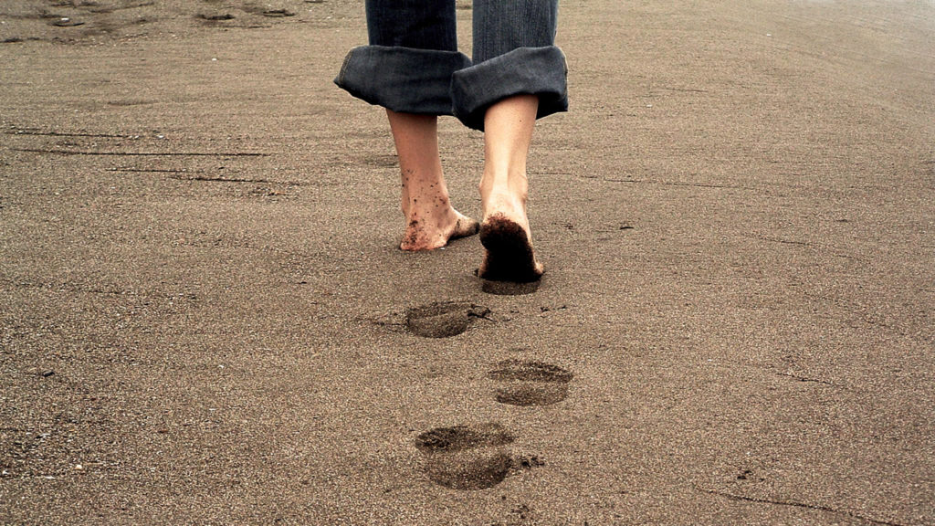 person walking on beach