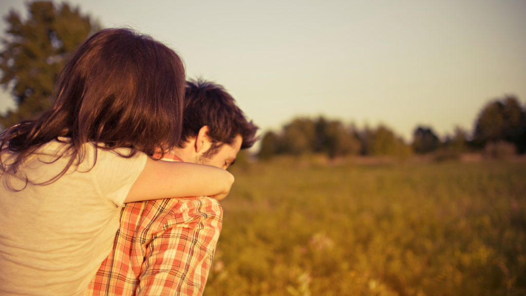 man giving girl piggy back ride