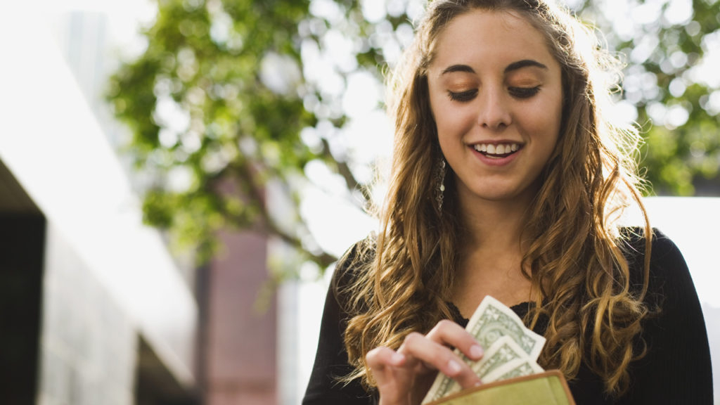 woman getting cash out of her purse