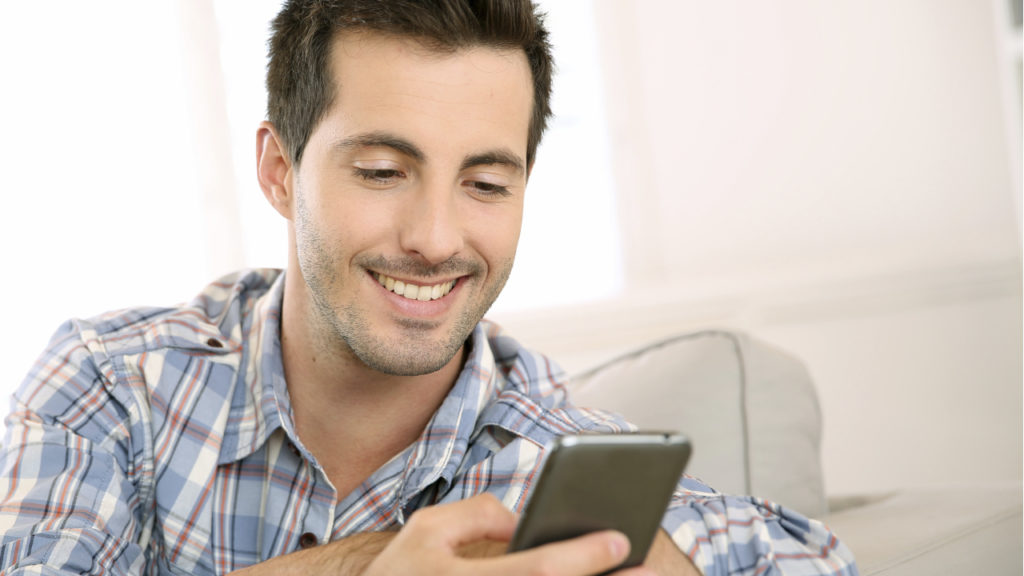 man smiling at phone