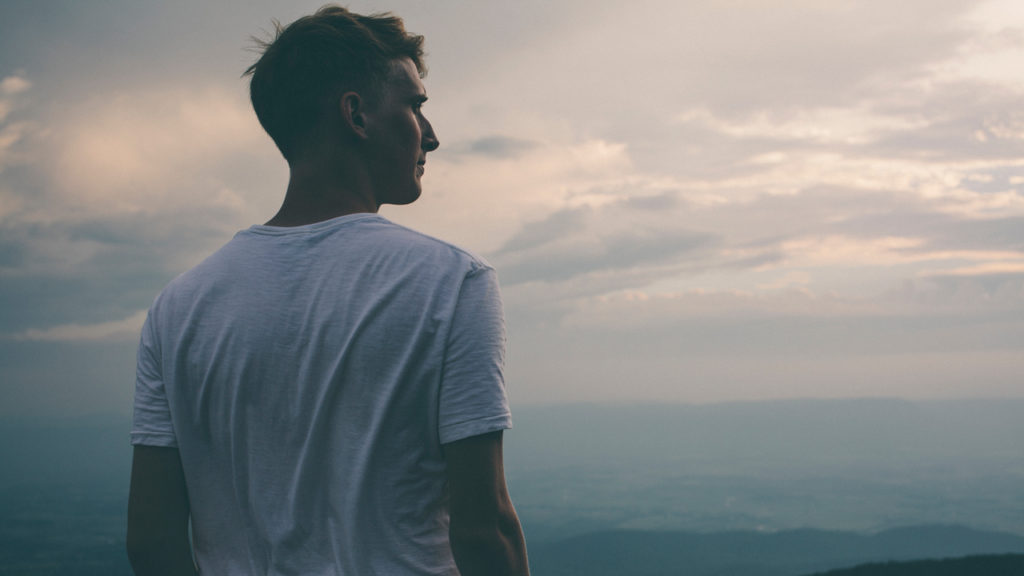 young man looking over ocean