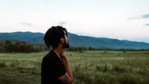 man looking over pasture