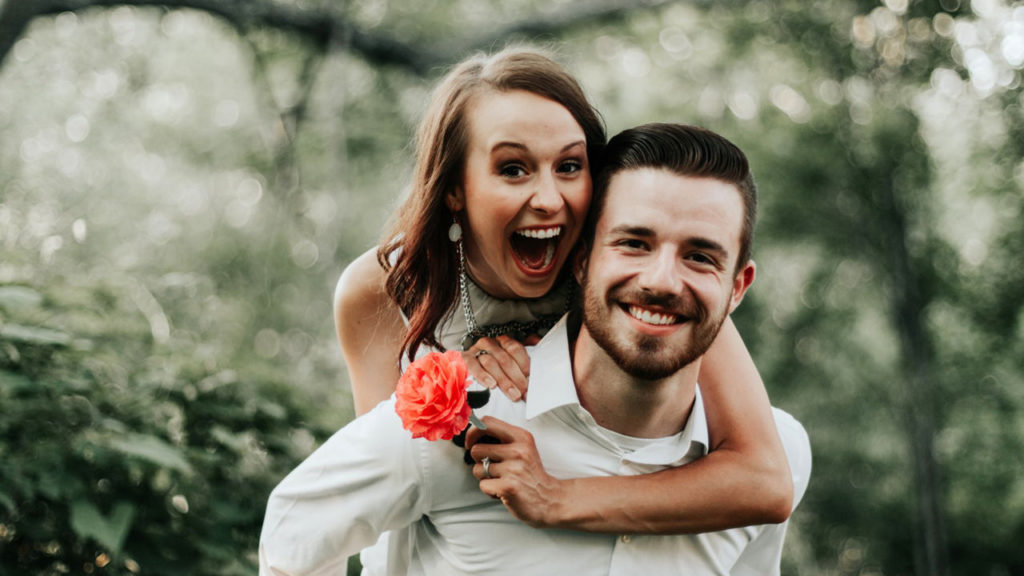 Woman on man's back smiling